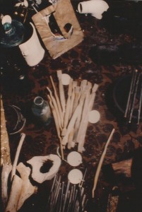 Ivory handled toothbrushes with hog bristles, a bottle, slate pencils, animal bones, part of a smoking pipe, and other artifacts.